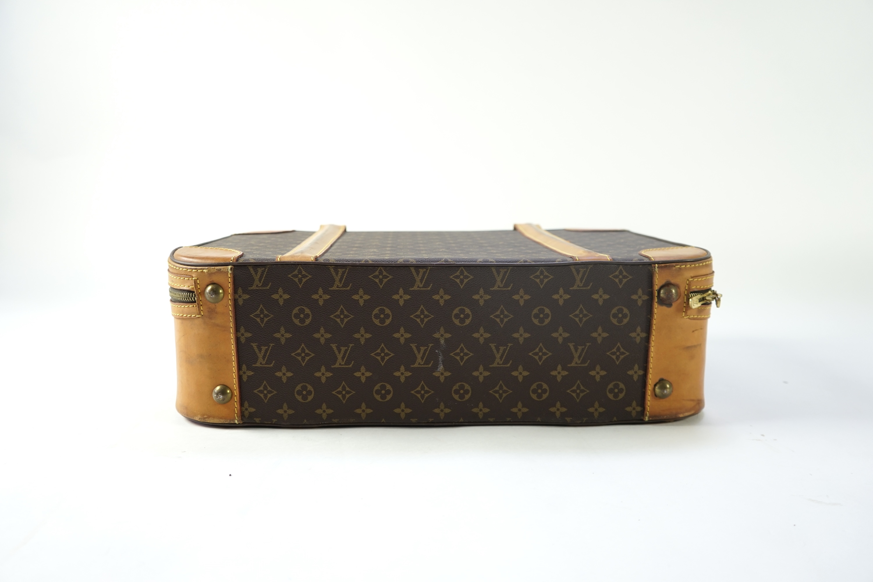 A Louis Vuitton monogrammed canvas with leather trim soft sided suitcase